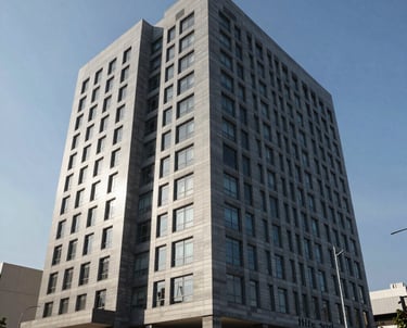 The sleek exterior of a modern administrative building in a South American business hub, blue sky background, representing authority and modern legal expertise.
