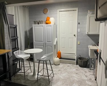 organized space with cupboards and table with barstools