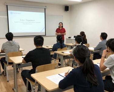 A professional trainer guiding a small group in a bright, modern office.