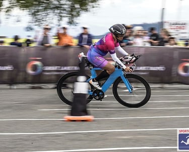 Janice McDonald sporting a CFL Tri Club Kit riding her sky blue time trial bike in IM New Zealand.