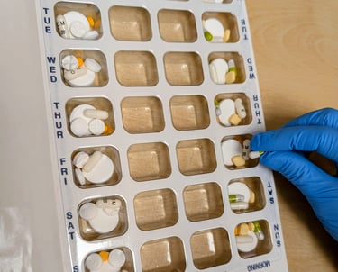 pharmacist checking weekly dossette box waverley pharmacy aberdeen