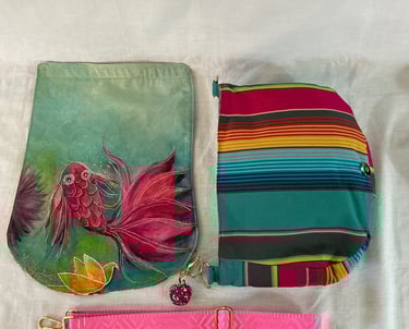 Handmade silk koi fish crossbody bag with a colorful striped pattern and a pink adjustable strap.