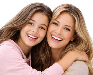 A smiling mother and daughter with healthy white teeth and long blonde hair hugging on a black background.