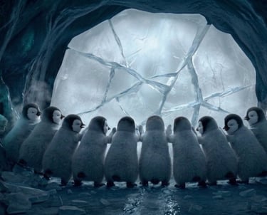 A group of fluffy baby penguins huddle together inside a frozen ice cave looking at a cracked icy wall.