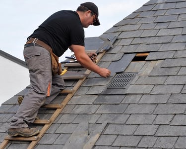Roofing Specialists Yorkshire. Roofer repairing damaged roof tiles