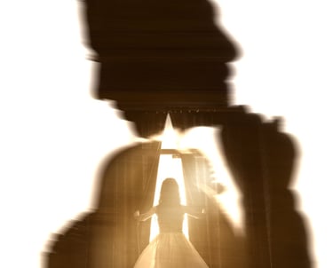 Double exposure silhouette of a bride in a wedding gown standing by a window with bright light.