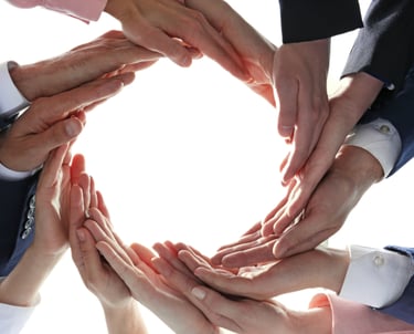 Hands coming together to form a circle