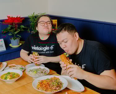 Founders enjoying bánh mì and Vietnamese dishes at a table inside Vietologie in Töölö, Helsinki