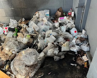 pile of trash in garbage enclosure