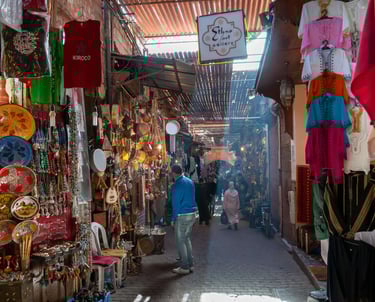 Moroccan traditional market in Marrakech with locals and spices