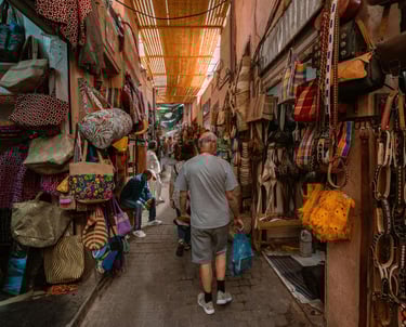 Colorful market stalls bustling with locals in Marrakech’s medina.