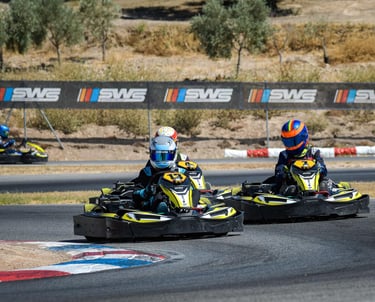 two people racing karts on a track