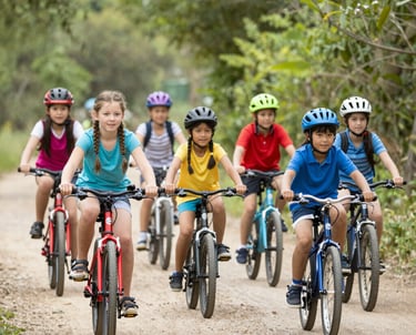 A scenic mountain trail with runners enjoying a trail run under clear blue skies.