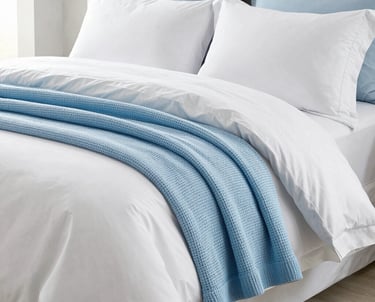 Minimalist kitchen with stainless steel appliances and polished metal fixtures reflecting soft natural light.