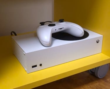 a turntable with a white controller and a yellow shelf