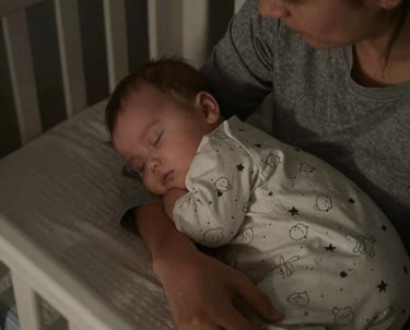 A serene nursery with a sleeping baby wrapped in a soft blanket under gentle lighting.