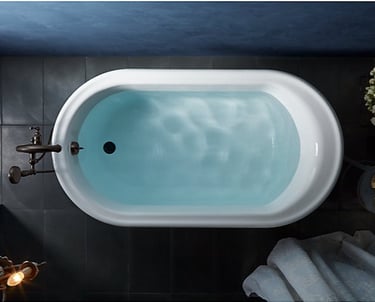 a bathtub with a blue skylight and a white bathtub