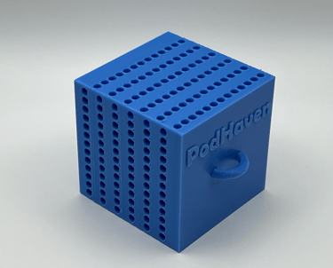 Blue 3D printed PodHaven storage cube with small holes for copepods and a ring handle.