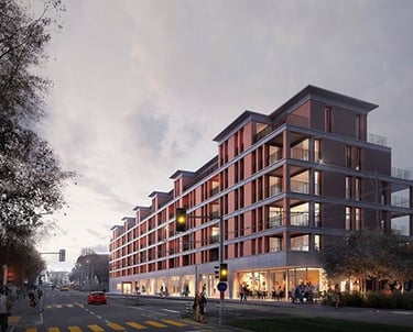Six-story apartment building with retail on the ground floor, earthy red and brown tones.