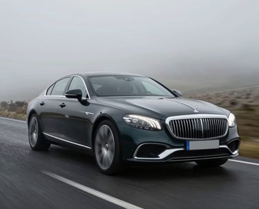 A high-end cinematic still showing a luxury car driving through a misty landscape, representing the film quality produced by the agency.