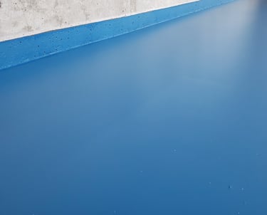Blue epoxy garage floor with seamless residential finish