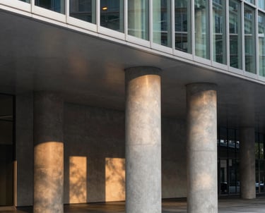 A warm, sun-drenched photo of a family laughing together outdoors, with soft sand tones and terracotta accents.