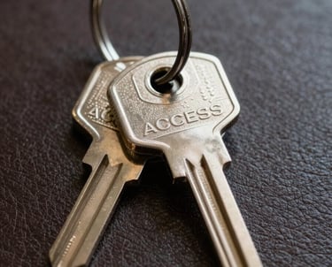 Close-up of a set of legal keys on a heavy metal ring resting on a leather surface. Soft, professional lighting. Symbolic of access and security.
