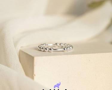 a ring with a diamond ring on top of a white surface