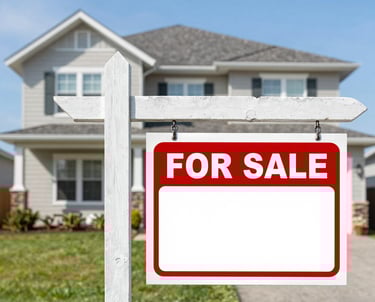 A happy homeowner holding a large stack of cash next to a 'For Sale' sign.