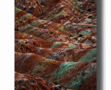 A stunning landscape print with deep terracotta and sage green hues, inspired by the North American southwest, displayed in a cinematic light.