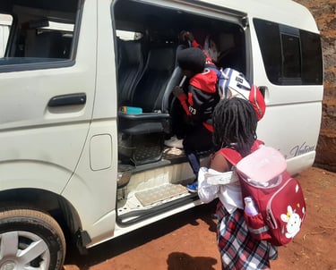 Students wearing backpacks boarding a Vanna Ventures van for private school transport services