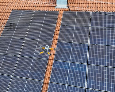 A thermal imaging drone performing an aerial maintenance inspection of residential solar panels on a tile roof.