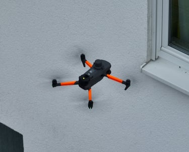 A thermal DJI drone scan the side of a white stucco building wall.