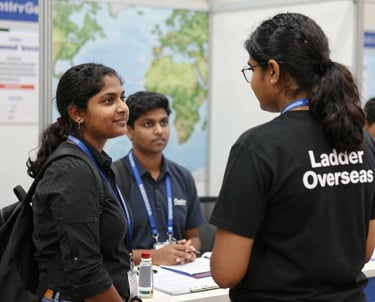 A confident Indian student consulting with a friendly advisor in a modern office setting.