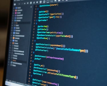 Macro shot of a high-resolution screen showing colorful code and design elements in shades of turquoise and deep blue. Professional tech atmosphere.