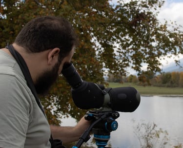a man with a spotting scope and a spotting scopeon a tripod