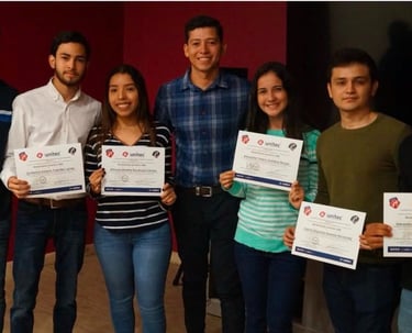 a group of people standing around a table with certificates