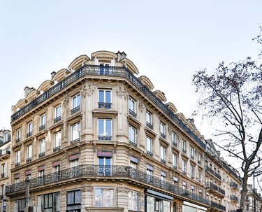 a building with a clock tower in the middle of the street