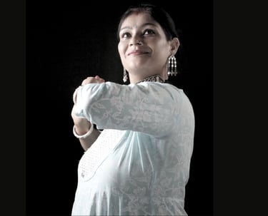 A woman demonstrating a kathak dance pose. She is Ms. Rachita, Founder of Thirkan Lalit Kkala Kendra