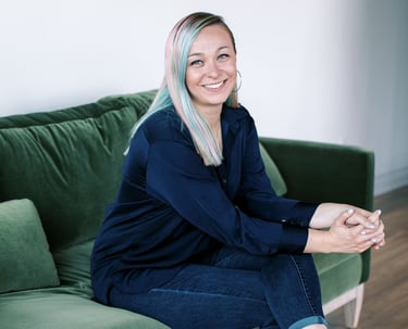 Tabitha with butterfly effect consulting sitting on a couch with her feet on the floor