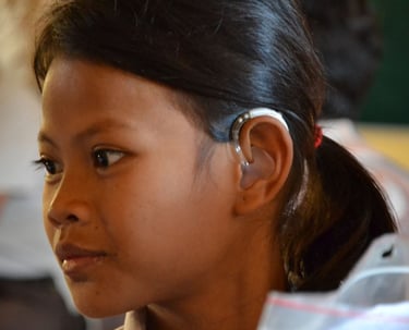 a young girl with hearing aid on her left ear