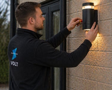 Northern volt employee installing outside light