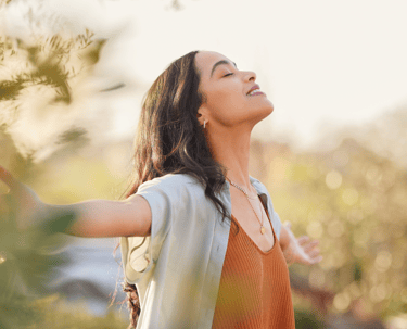 brunette women spreading her arms out living a fulfilling life