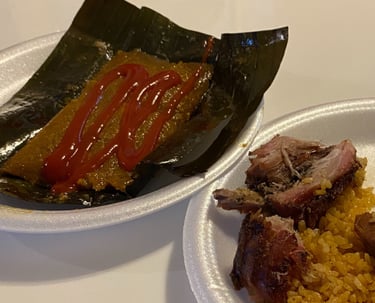 a plate of puerto rican pasteles pernil and arroz con gandules
