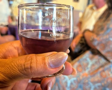 a person holding a glass of lavender squash during a Cyprus culture tour