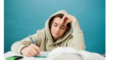 A stressed student working on homework