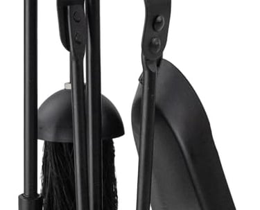 a black and white candle holder with a broom and a broom