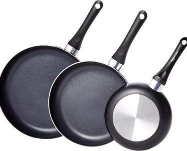 a group of three frying pans with a pancake