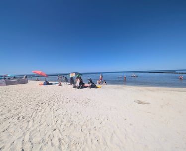 Families enjoying a sunny summer day on a sandy beach at the Baltic Sea in Poland