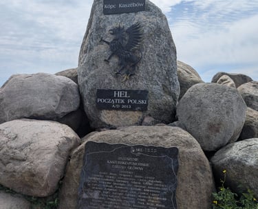 Stone monument in Hel marking the symbolic beginning of Poland with historic engraving